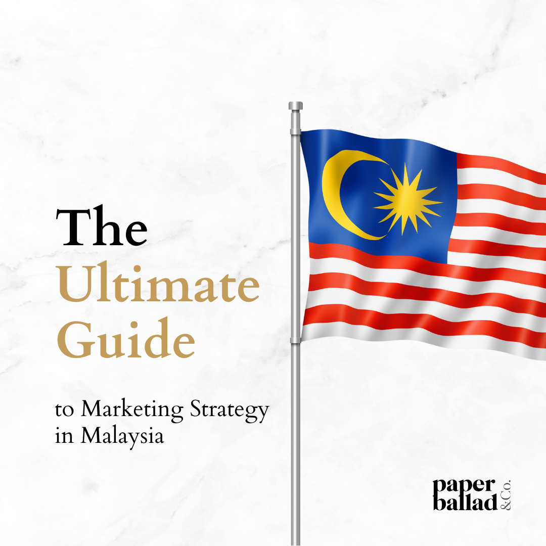 A Malaysian flag hoisted up next to a gold text saying "The Ultimate Guide to Marketing Strategy in Malaysia".